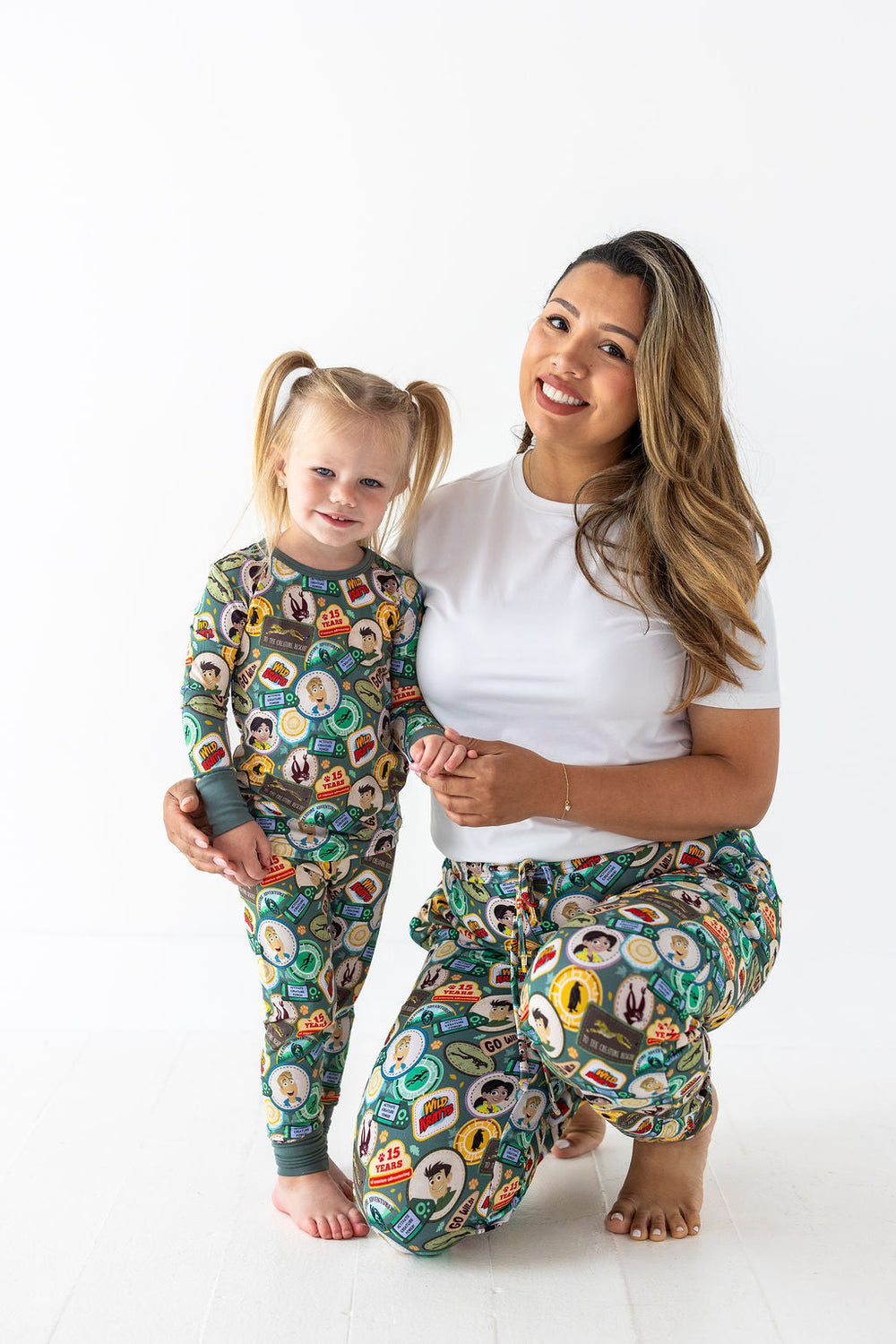 Mom and daughter matching in Wild Kratts® Anniversary Collection pajamas and adult joggers
